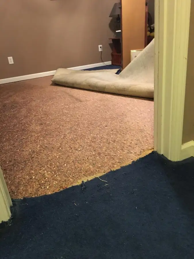 Carpet pad removal revealing water damage during Drying & Dehumidification in DeRidder
